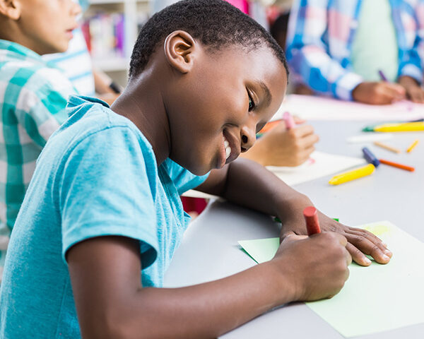 Schoolboy drawing on paper