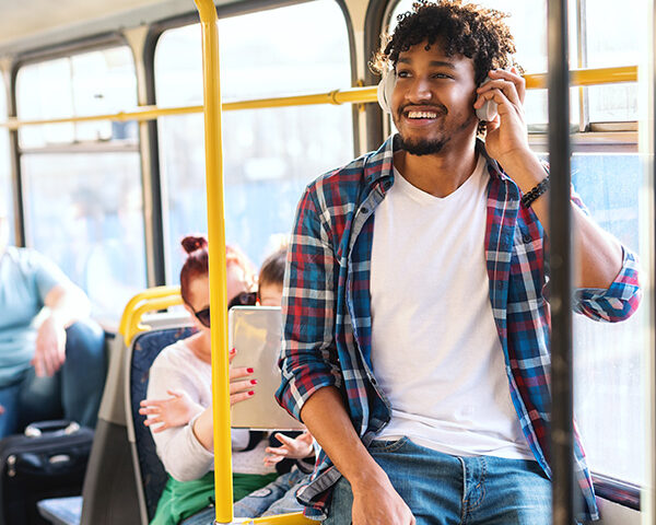 Young African guy listening to the music while riding in public
